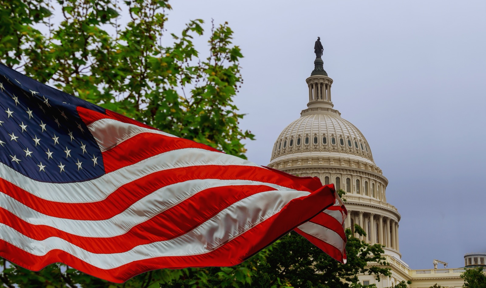 The United States Capitol with an American flag