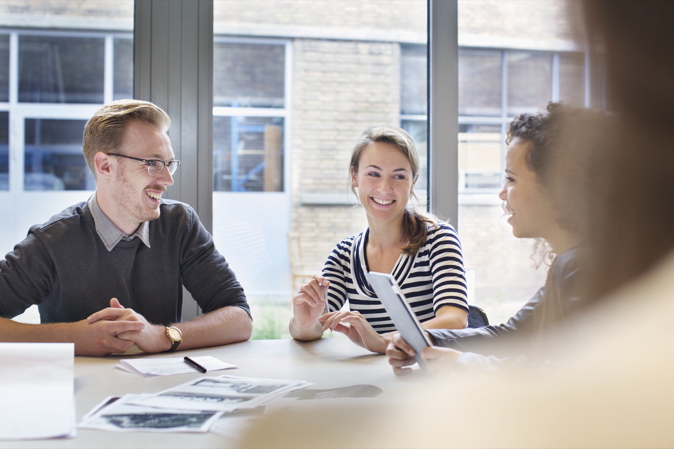A team working through documents at a conference table
